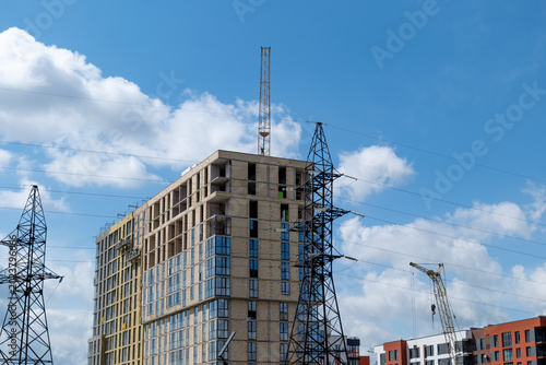 Slika na platnu Construction is underway for a new house with cranes and power lines visible und