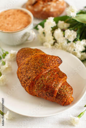 Breakfast with fresh cappuccino and croissant