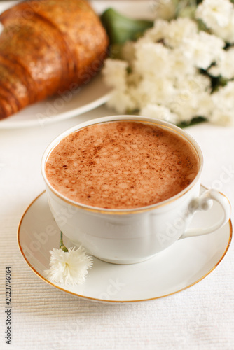 Breakfast with fresh cappuccino and croissant