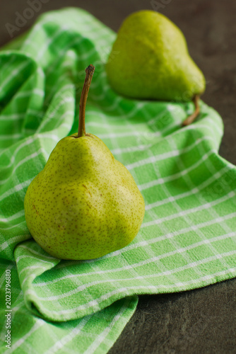 Fresh ripe organic summer pears on rustic wooden table	