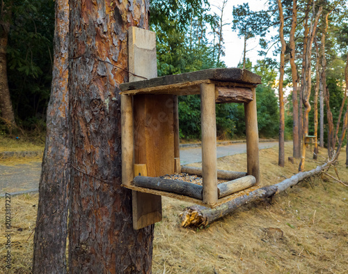 Homemade bird feeder made from round wooden sticks