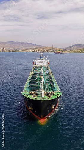 Aerial drone photo of crude Oil tanker ship underway towards open sea, a merchant ship specially designed for chemical products transportation