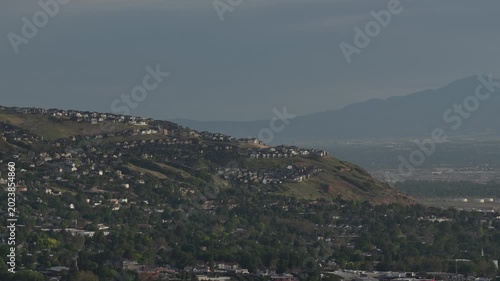 Aerial close up of hillside homes in Bountiful Utah at sunset with Wasatch Range