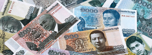 Billede på lærred Cambodian riel money banknotes pile on table