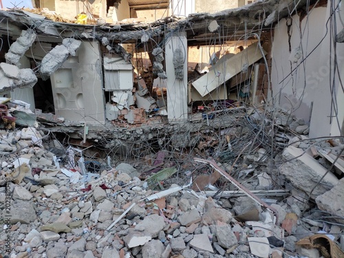 Tableau sur toile Interior view from within a destroyed building looking out onto rubble and damaged urban cityscape after earthquake disaster