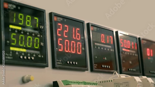 Square, black, glossy, digital power meters, network frequency meters and current consumption meters in industrial equipment. Closeup