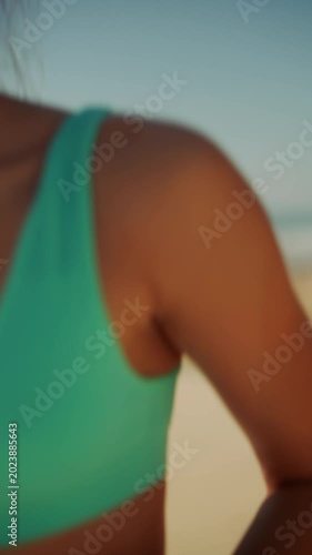 Beach fitness session showing focused woman with windtousled hair