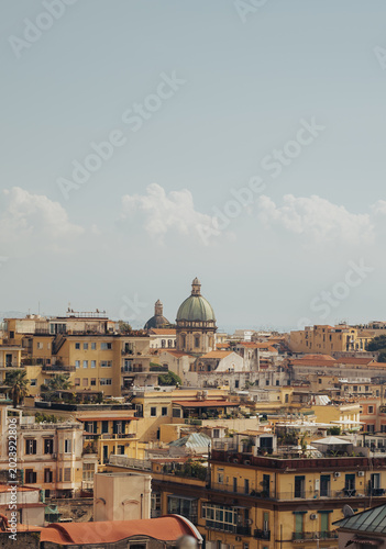view of the Basilica dello Spirito Santo church dome rising above historic residential buildings in Naples Italy