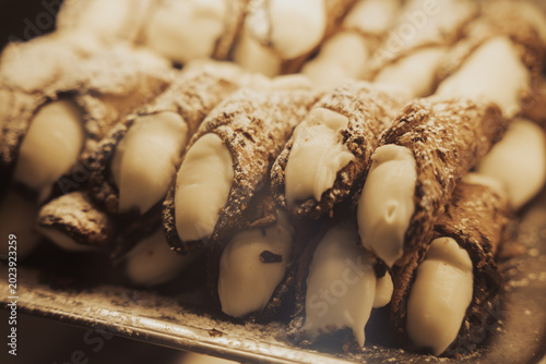 Traditional Sicilian cannoli on display in an authentic Italian bakery or pasticceria