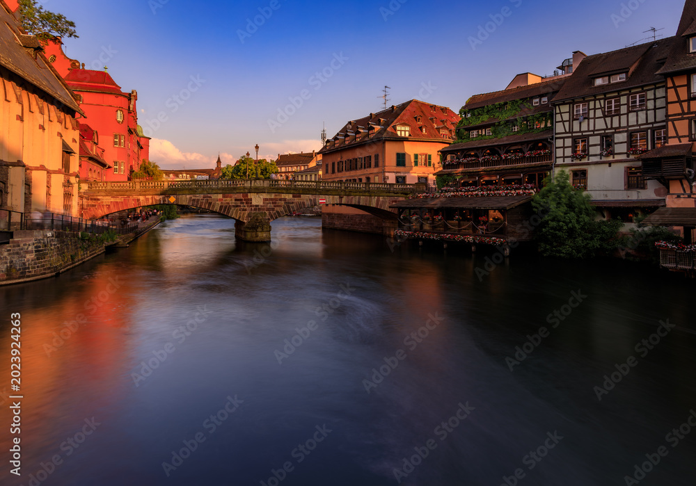 Obraz premium Half timbered houses by canals of Petite France in Strasbourg, France at sunset