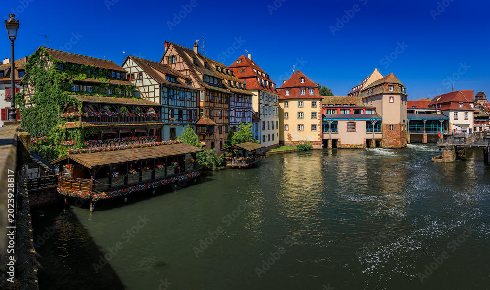 Obraz premium Half timbered houses with flowers, canals of Petite France in Strasbourg, France