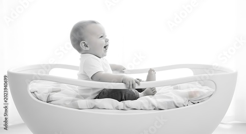 Baby sitting in a white chair.