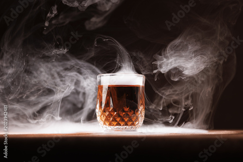 Quadro su tela Shot class of dark liquor (whiskey or brandy) centered with dramatic dry ice - smoke creating a custom cocktail appearance