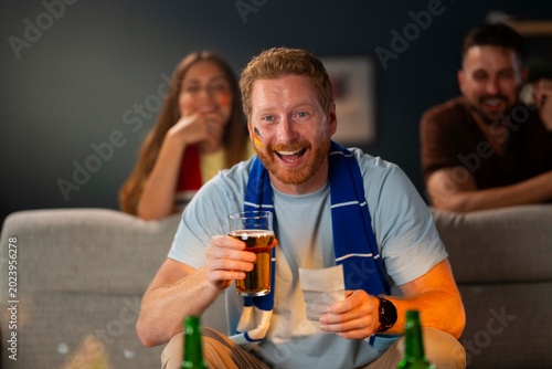 Foto Overjoyed soccer supporter celebrating a successful betting slip during a live football watch party with drinks and emotional reactions at home