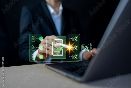 Businessman verifying digital document approval process with laptop in background