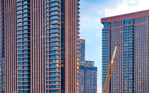 Photography Modern high-rise towers in Kuala Lumpur featuring contemporary architecture, geometric facades, and dense urban development within Malaysia’s vibrant metropolitan skyline
