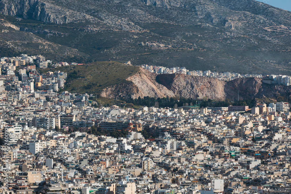 Fototapeta premium Athens, Attica, Greece, beautiful panoramic view of Athens cityscape, with The Parthenon, mountains, sea and scenery beyond the city, seen from Mount Lycabettus Hill observation deck in a sunny day