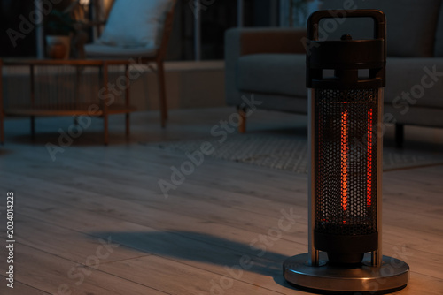 Foto Modern electric heater in living room at evening
