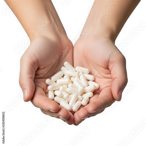 Pair of cupped hands holding a large pile of white medicinal capsule supplements.