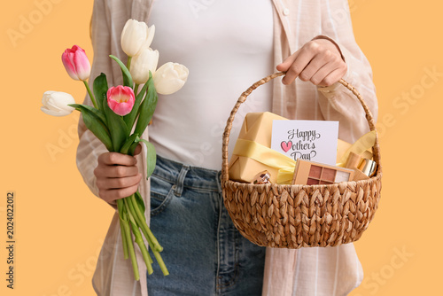 Young woman holding basket ...