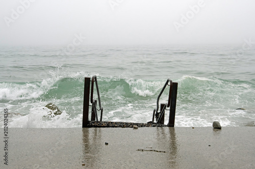 Waves crashing onto the shore on a foggy day