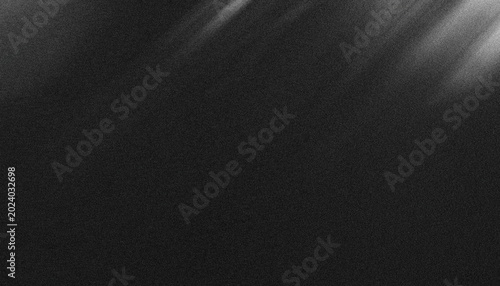Photos Diagonal light streaks cut through the dense black atmosphere to produce a subtle cinematic texture that evokes a sense of mystery and depth for professional design