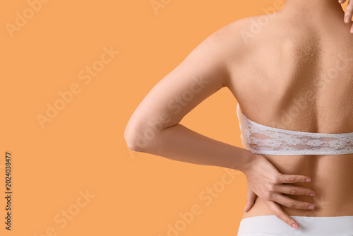 Young woman applying body s...
