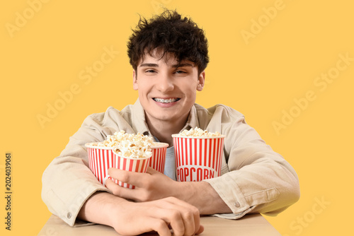 Young man with popcorn buck...