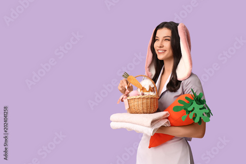 Happy female chambermaid in...