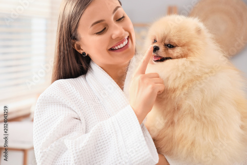 Young woman with cute Pomer...