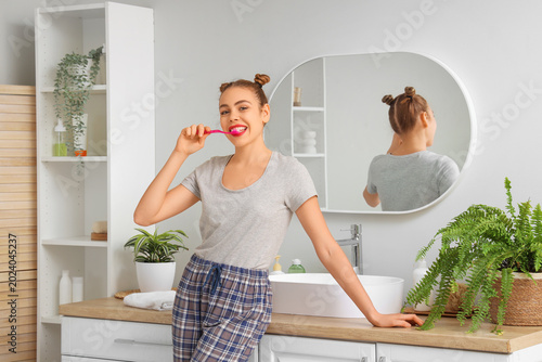 Beautiful young woman brush...