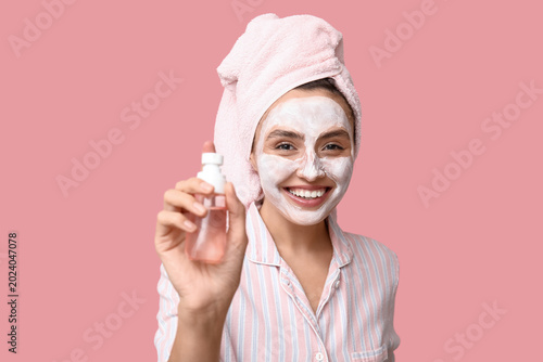 Young woman with bottle of ...