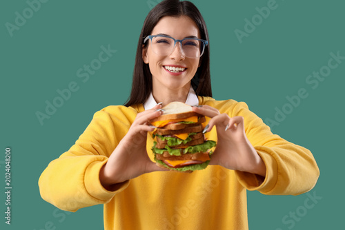 Young woman with big sandwi...