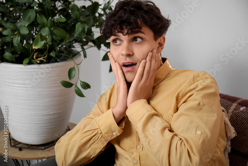 Portrait of shocked young m...