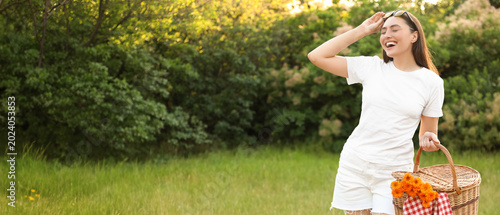 Young woman with picnic bas...