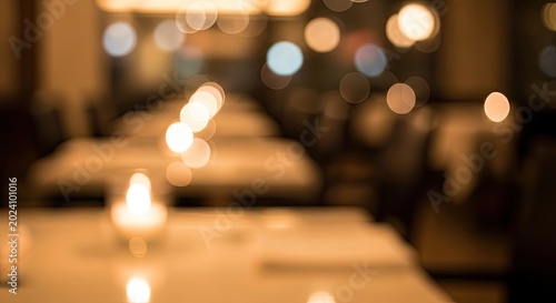 Warm blurred background of a romantic restaurant interior with bokeh lights at night.