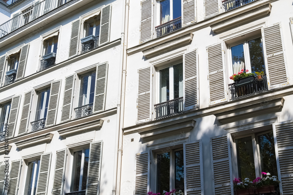 Obraz premium Paris, typical facade and windows, beautiful building rue de Babylone, detail of the facade 