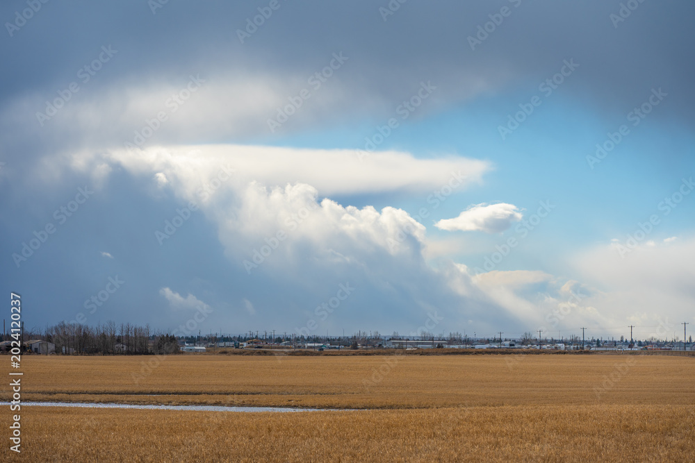 Fototapeta premium Farm field with storm clouds in the sky