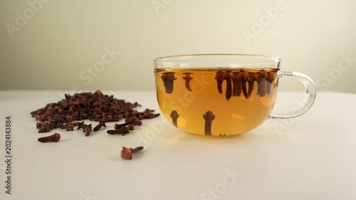 Clove tea on white table. Healthy drink.