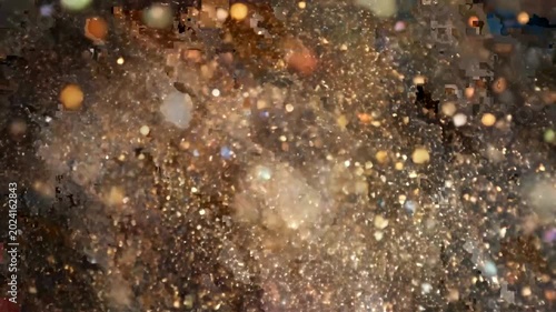 Abstract golden glitter explosion on dark background