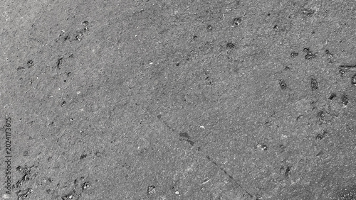Bild auf Leinwand Dark rough asphalt surface with scattered pebble texture
