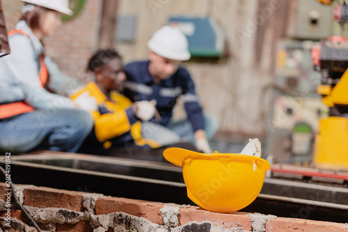Accident worker injured on site colleague help assist, urgency workplace safety, emergency response.