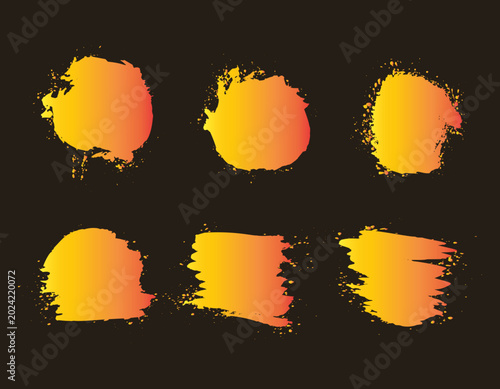Set of vibrant yellow and orange gradient grunge brush strokes, paint splatters, and abstract ink stains isolated on dark background. Graphic design elements for banners, labels, and text boxes.