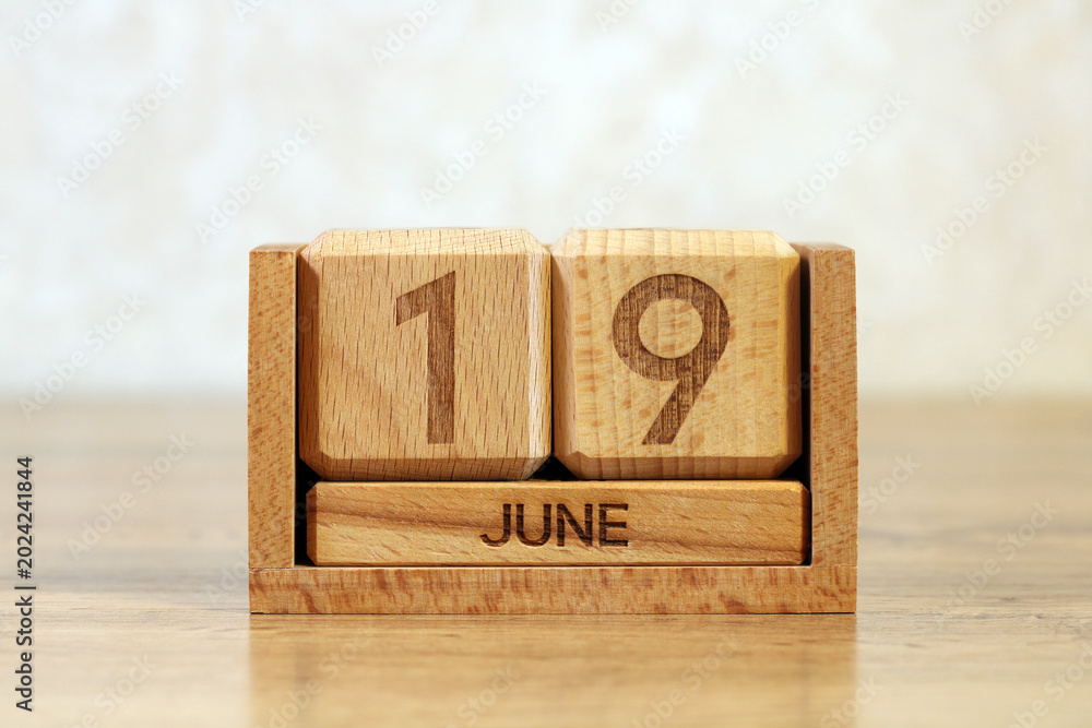 Αυτοκόλλητο Wooden Block Calendar Showing June 19 on Desk Close Up Date and Time Management