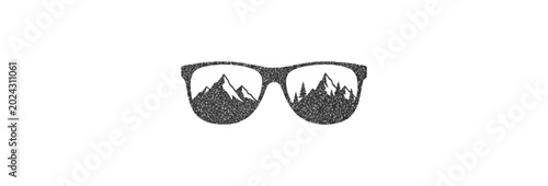 Sunglasses with mountain range reflection against black backdrop