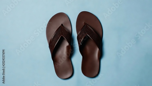 Brown Flip Flops on Blue Background Perfect for Summer and Casual Footwear Use
