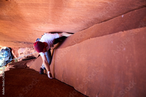 Obraz na plátně Person crack climbing sandstone in a narrow desert canyon