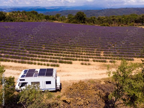 Caravan with solar panels on roof camping at lavender field