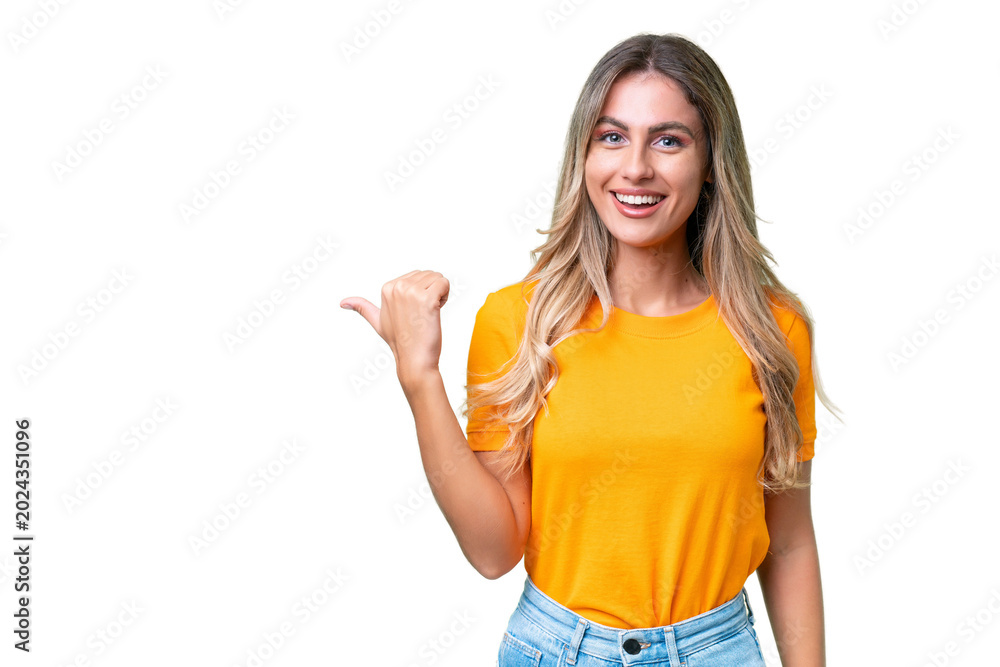 Fototapeta premium Young Uruguayan woman over isolated background pointing to the side to present a product