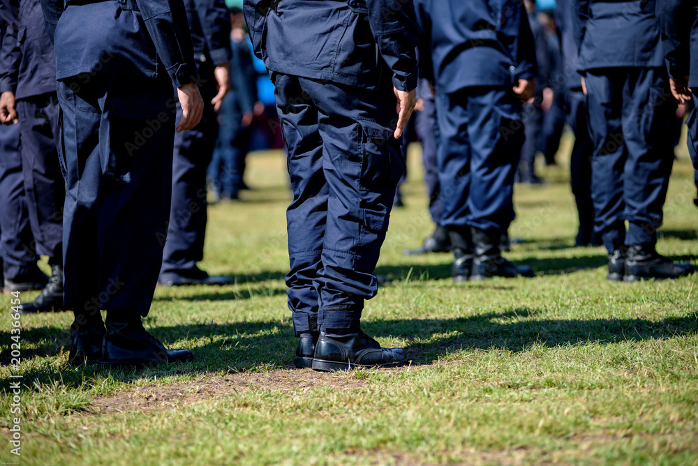 Fototapeta premium Riot police control the crowd practice and review on the grass field.